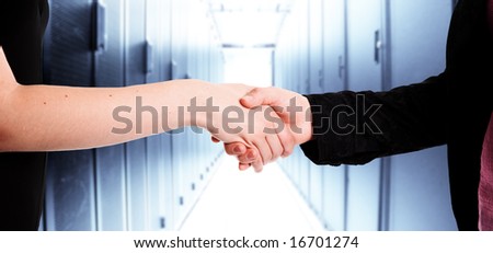 Two businesswomen handshake in a data center
