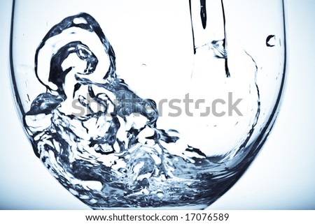 A shot of fresh water poured into a glass