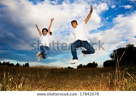 A shot of a happy asian couple jumping for joy