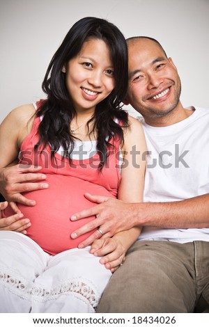 A happy asian couple expecting for their unborn baby