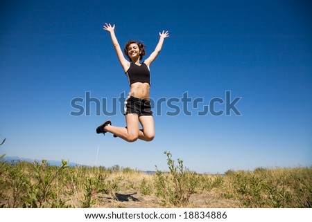 A beautiful sporty caucasian girl jumping for joy