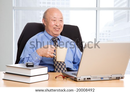 A senior asian businessman working in the office