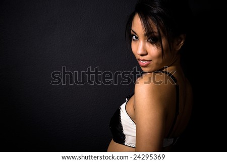 A beautiful sexy african american woman wearing lingerie shot in black background