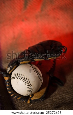 A shot of a baseball ball and a baseball glove on a grunge background