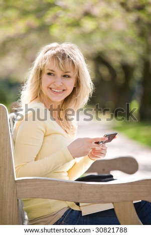 A shot of  a beautiful caucasian college students texting text messages on campus