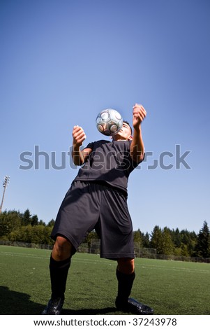 A shot of a hispanic soccer or football player controlling the ball with his chest