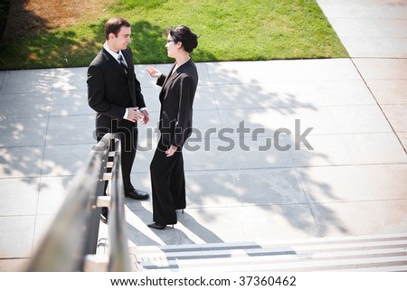 A shot of two business people having a discussion outdoor