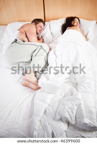 A shot of sleeping interracial couple on their bed