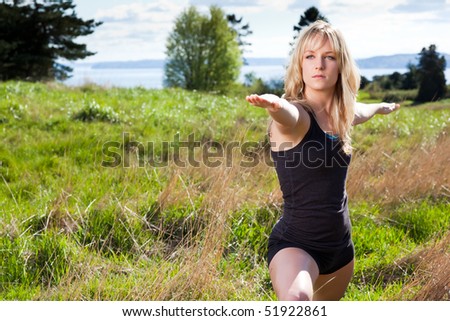 A beautiful caucasian woman practicing yoga outdoor in a park