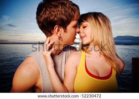 A shot of a young caucasian couple kissing outdoor