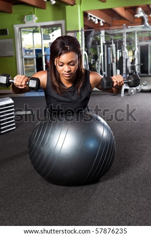 A shot of a black female athlete training and lifting weights