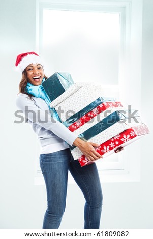 A black woman celebrating christmas carrying gift boxes