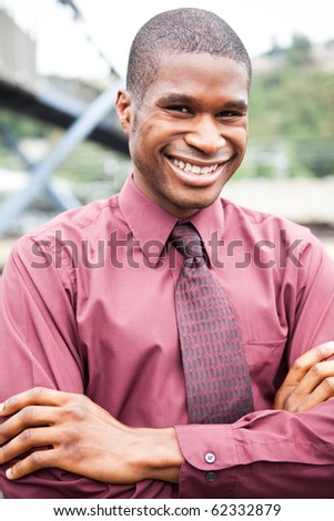 A portrait of a smiling black businessman outdoor