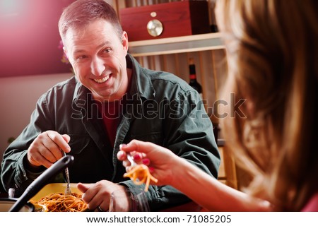 A shot of a caucasian couple having dinner at home