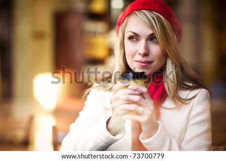 A shot of a beautiful caucasian woman drinking coffee at a cafe