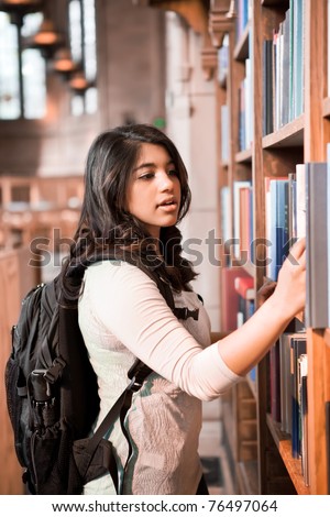 A shot of an asian student getting books in a library
