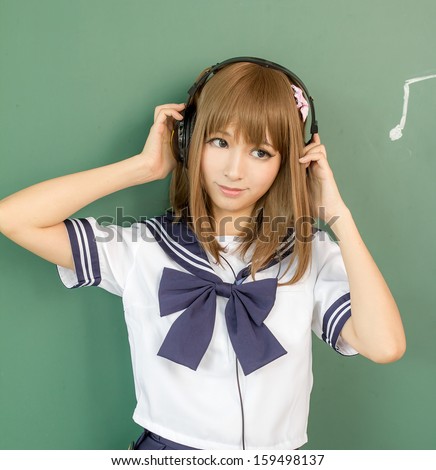 Asin girl in student sailor suit  japanese style listen to music / headset,\
earphone