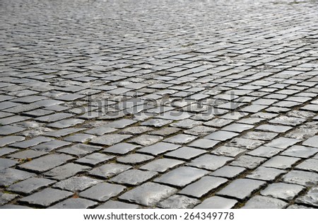Abstract background of old cobblestone pavement close up.