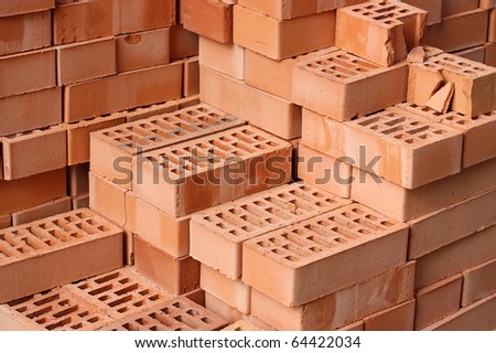 Heap of red bricks close up.