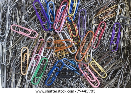 Background. Many writing paper clips.