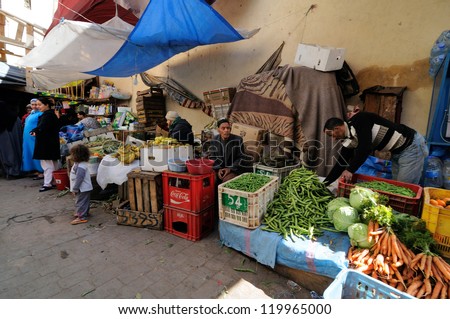 FES - MARCH 10: Unknown man trades a vegetables in a Market (souk) in a city Fes in Morocco. The market is one of the most important attractions of the city. March 10, 2012 Fes, Morocco.