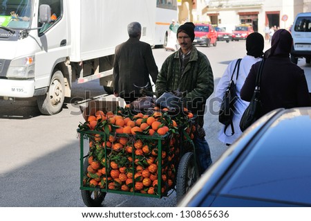 FES - MARCH 10: Unidentified Arabic people carrying fruits in a city Fes in Morocco. Fes is a historic city listed in UNESCO. March 10, 2012 Fes, Morocco.