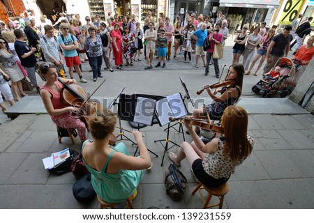 VILNIUS, LITHUANIA - MAY 18: Unidentified musician play violin in Street music day on May 18, 2013 in Vilnius. Its a most popular event on May in Vilnius, Lithuania