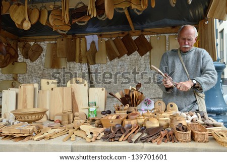 VILNIUS, LITHUANIA - MAY 24 : Unidentified people carve wood in the street during a International Folklore Festival on May 24 2013 in Vilnius, Lithuania.