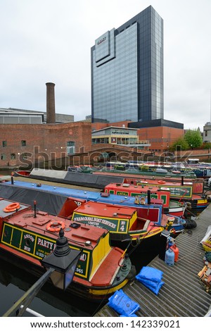 BIRMINGHAM, ENGLAND - JUNE 12: Colorful narrow boat, typical houseboats in West Midlands, England on June 12, 2013. Birmingham Canal is popular for leisure and has a number of narrow boat hire centers