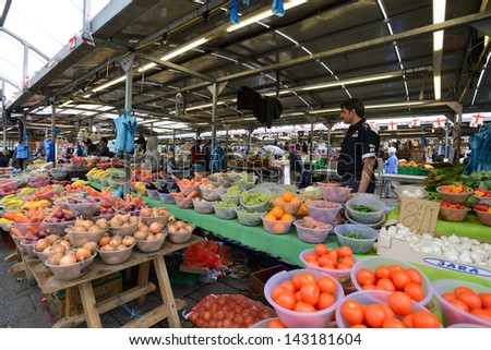 BIRMINGHAM, ENGLAND - JUNE 13: Unknown man trades a fruits in Bull Ring market on June 13, 2013 in Birmingham, England. Birmingham's outdoor Bull Ring market sees over six million shoppers every year