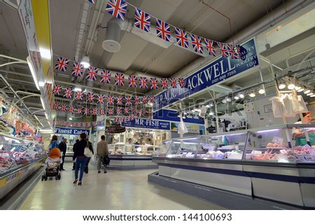BIRMINGHAM, ENGLAND - JUNE 13: Unknown man trades a food in Bull Ring market on June 13, 2013 in Birmingham, England. Birmingham\'s indoor Bull Ring market sees over six million shoppers every year