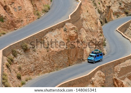 DADES GORGES, MOROCCO - JULY 11: Overloaded car on a winding road, July 11, 2013 in Dades Gorges, Morocco. Road in Dades Gorges very popular tourist route in east Morocco.