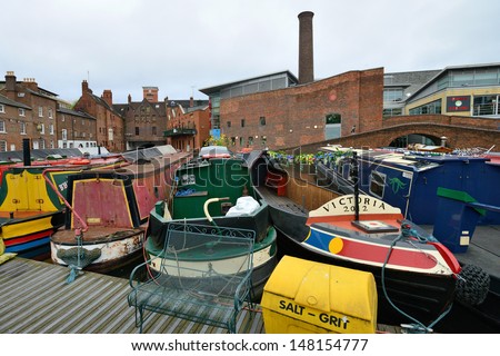 BIRMINGHAM, ENGLAND - JUNE 12: Colorful narrow boat, typical houseboats in West Midlands, England on June 12, 2013. Birmingham Canal is popular for leisure and has a number of narrow boat hire centers