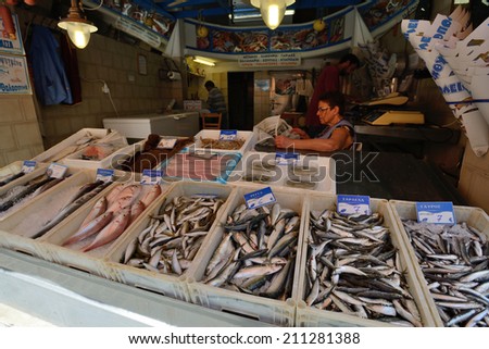 CRETE, RETHYMNO - AUGUST 09: Unknown people sell fresh fish in Rethymno, Crete, Greece on 09 August 2014. Rethymno is the third largest city in Crete and the capital of regional unit.