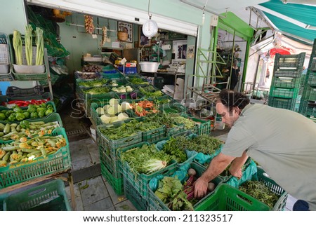 CRETE, HERAKLION - AUGUST 09: Unknown people sell fresh vegetables in Heraklion, Crete, Greece on 09 August 2014. Heraklion, the capital of the island of Crete, Greece