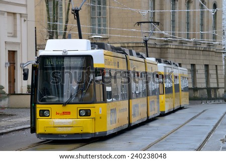 BERLIN - DECEMBER 26: Yellow tram on city street on December 26, 2014 in Berlin, Germany. The tram in Berlin is one of the oldest tram systems in the world.