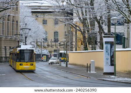 BERLIN - DECEMBER 26: Yellow tram in city street on December 26, 2014 in Berlin, Germany. The tram in Berlin is one of the oldest tram systems in the world.