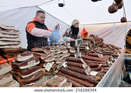 VILNIUS, LITHUANIA - MARCH 6: Unidentified people trade smoked meat in annual traditional crafts fair - Kaziuko fair on Mar 6, 2015 in Vilnius, Lithuania