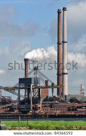 Factory with smoke on sky