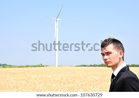 Business man standing in wheat