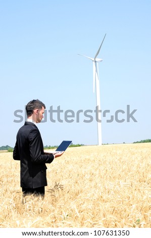 Business man standing in grain