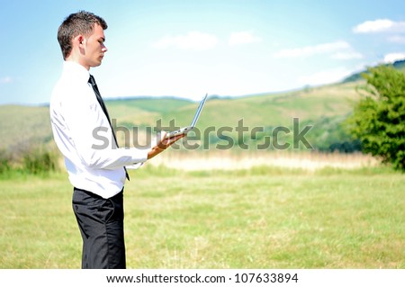 Business man with notebook in nature