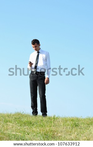 Business man standing in nature