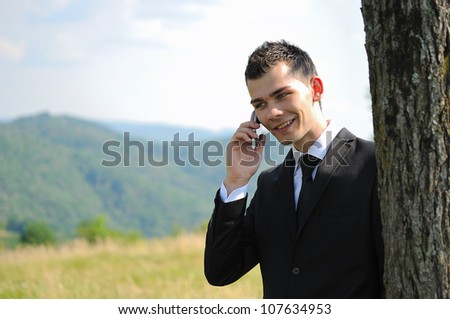 Business man with phone in nature