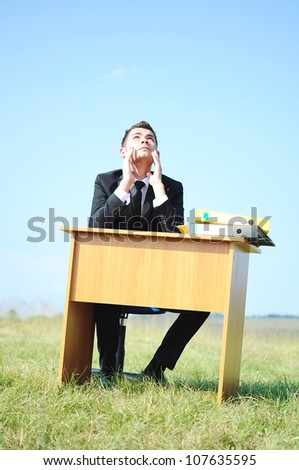 Business man at desk in nature