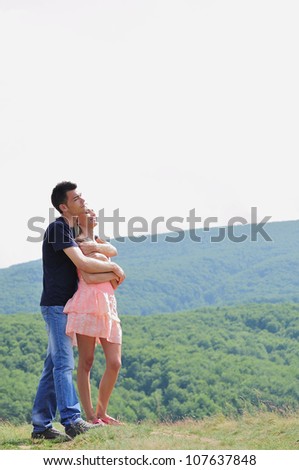 Young couple hugging in nature