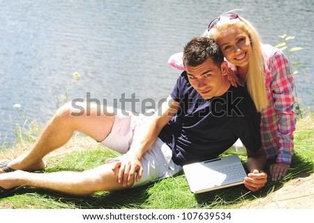 Young couple at notebook in nature