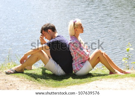 Young couple thinking at lake