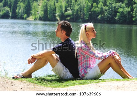 Young couple thinking at lake