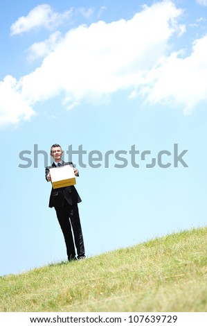 Business man delivering box in nature